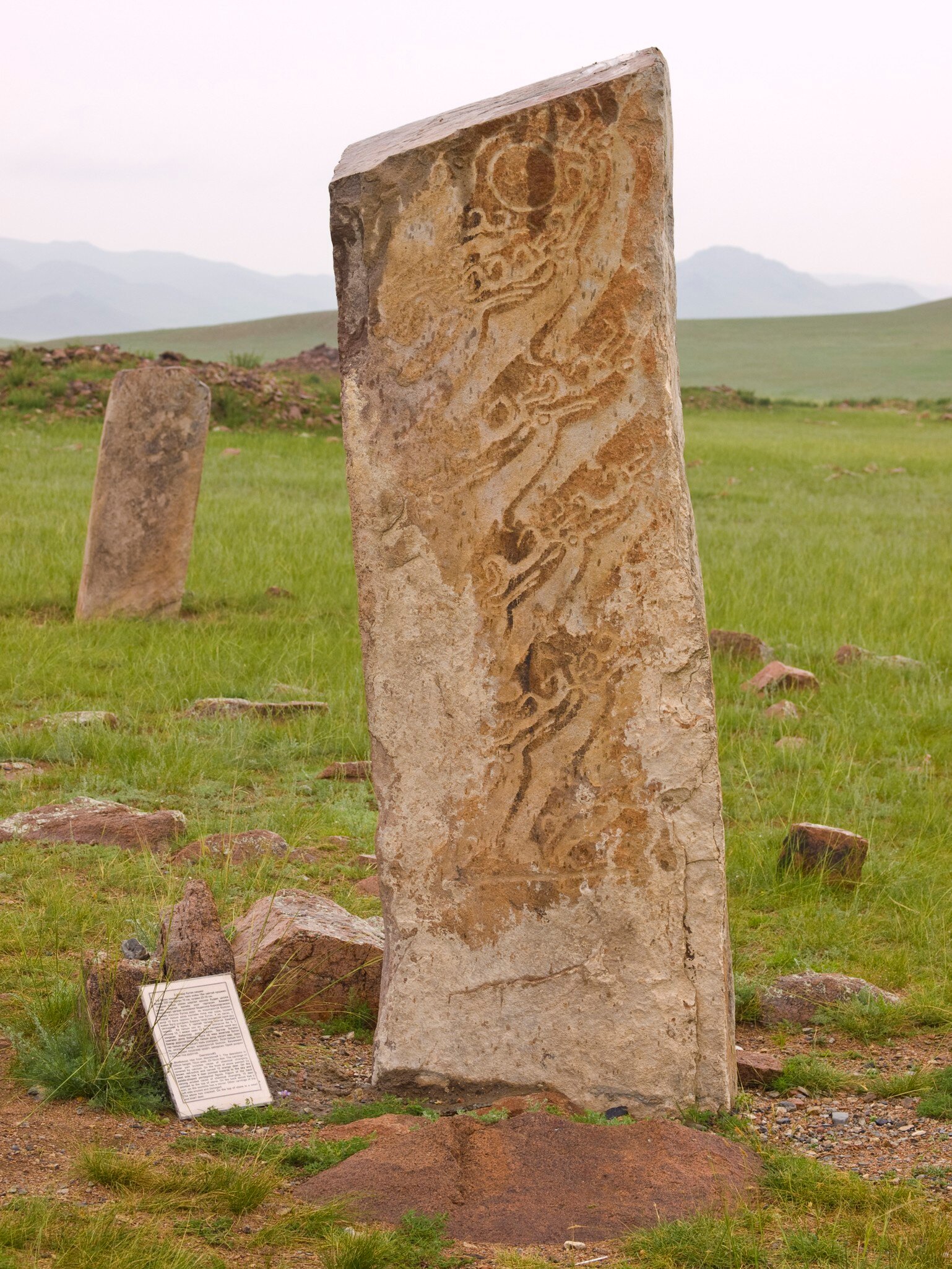 "Deer stone in Uushigiin Uver, Mongolia. Megalithic monuments  ancient burials from Huns,  monuments of rock art with a feeling of mysterious ancient times, Deer and antlers are carved in them."