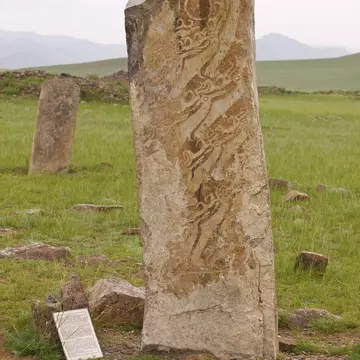 "Deer stone in Uushigiin Uver, Mongolia. Megalithic monuments  ancient burials from Huns,  monuments of rock art with a feeling of mysterious ancient times, Deer and antlers are carved in them."