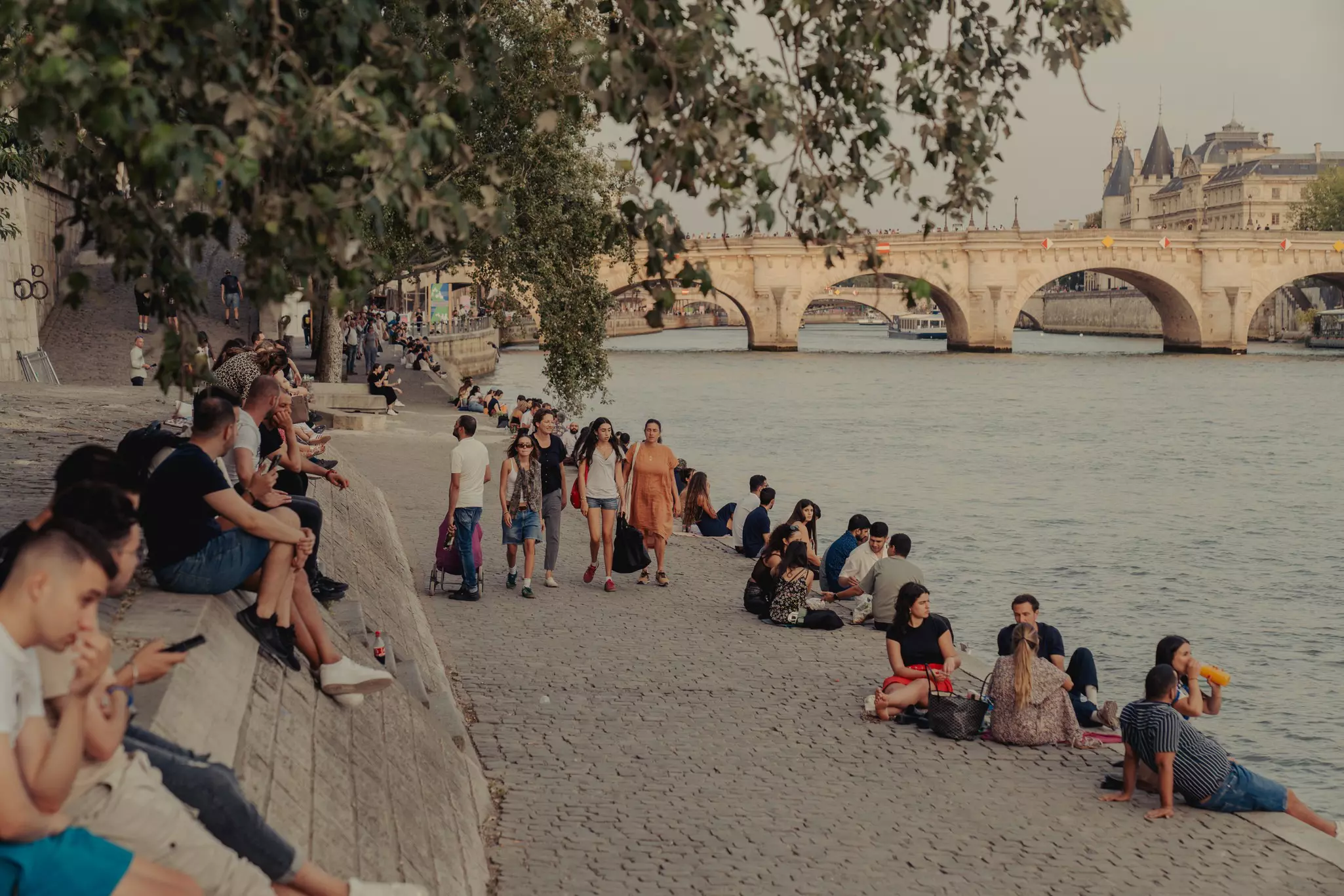 Parisians relax along the Seine the Quai de L’Hotel De Ville