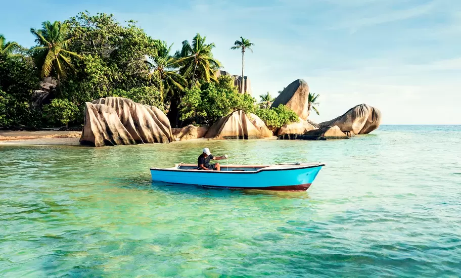 A man fishing off Anse Source d'Argent beach in the Seychelles