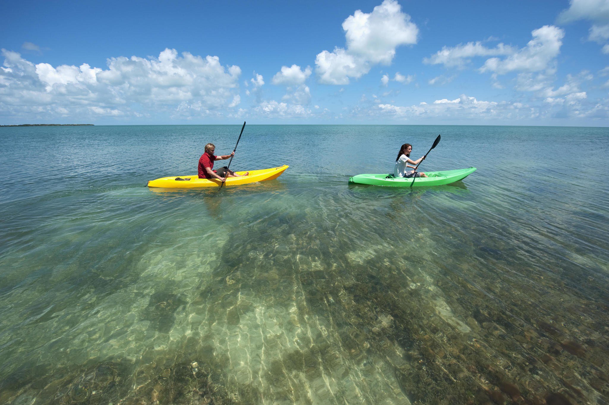 Man and a woman in kayaks at Key West.