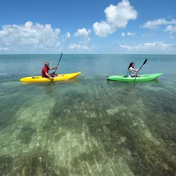 Man and a woman in kayaks at Key West.