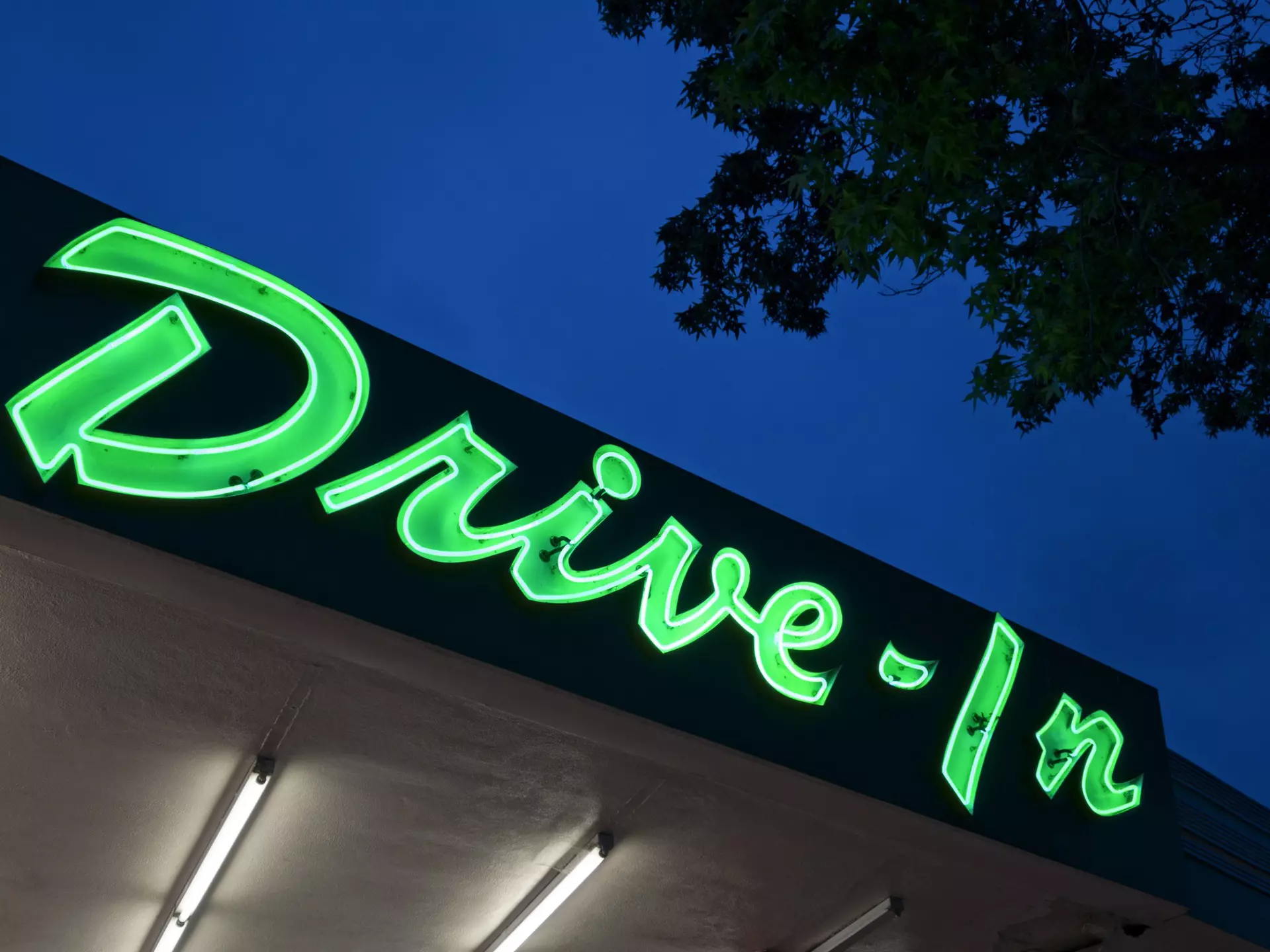 Neon drive in sign at dusk