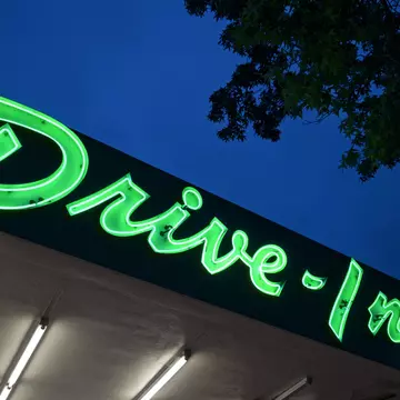 Neon drive in sign at dusk