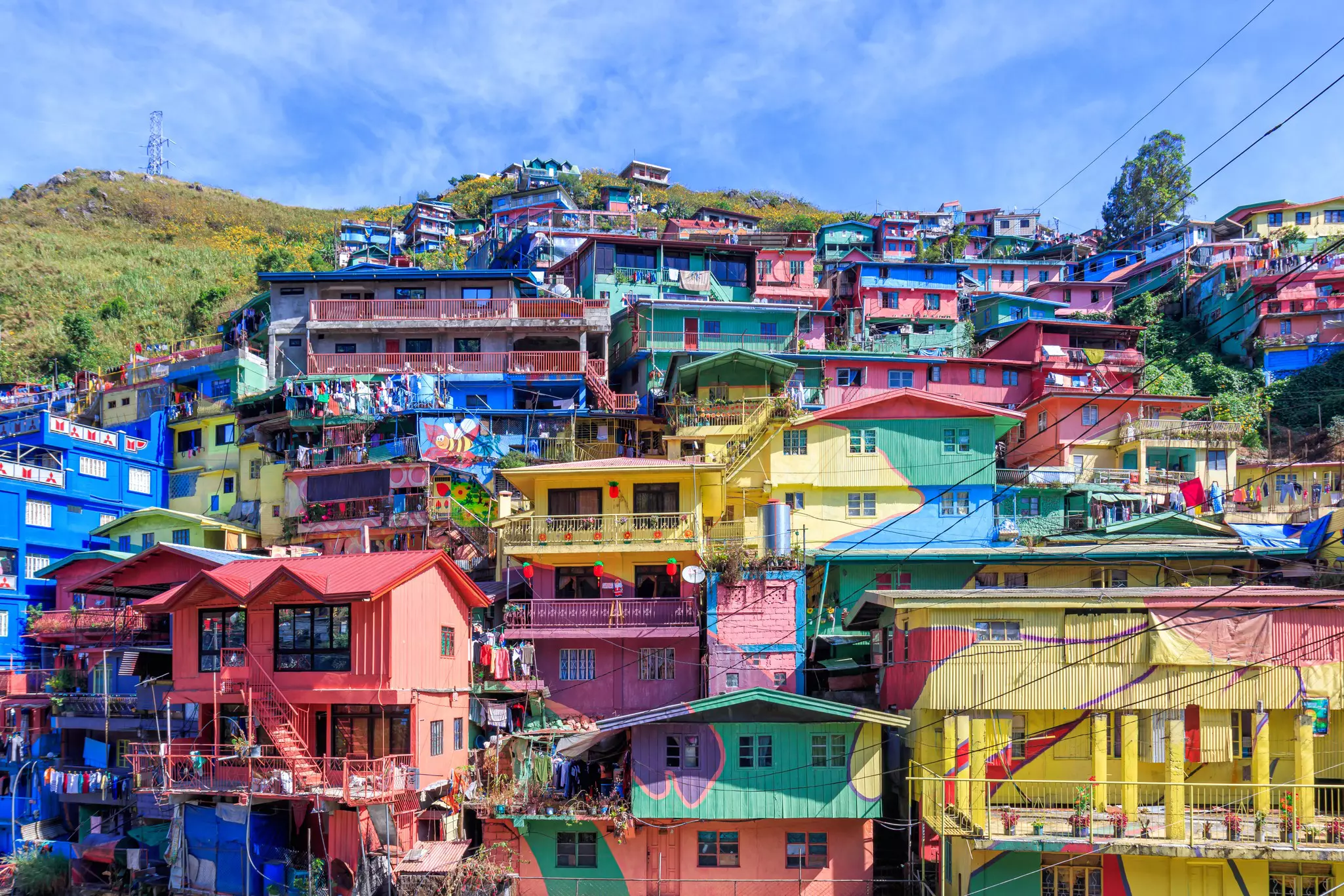 A series of brightly colored houses built into the side of a hill.
