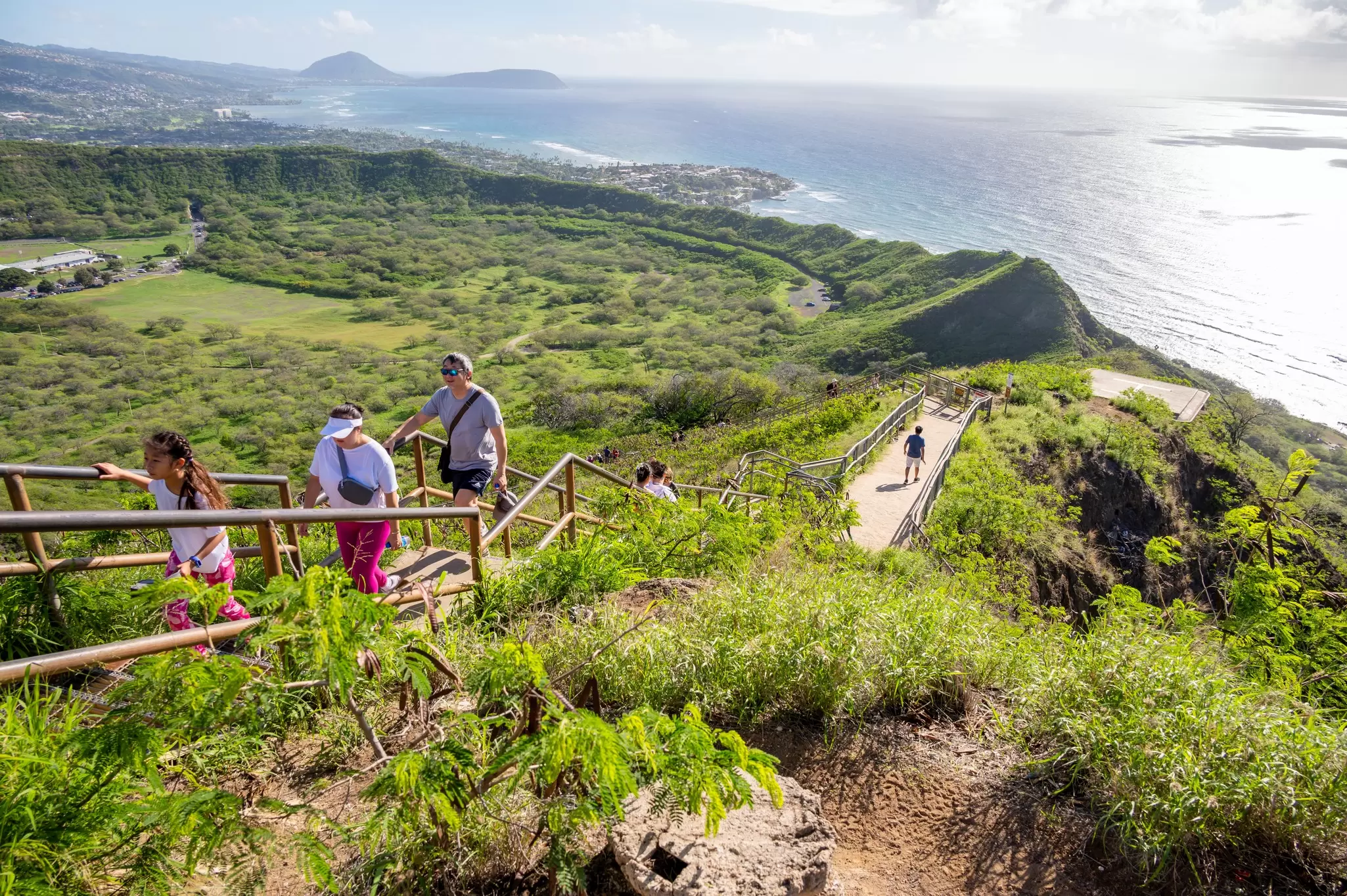 People walking up the trail to the top of Diamond Head. iStock