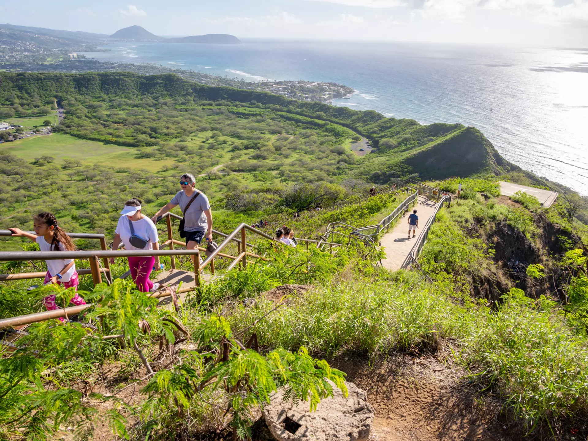 People walking up the trail to the top of Diamond Head. iStock