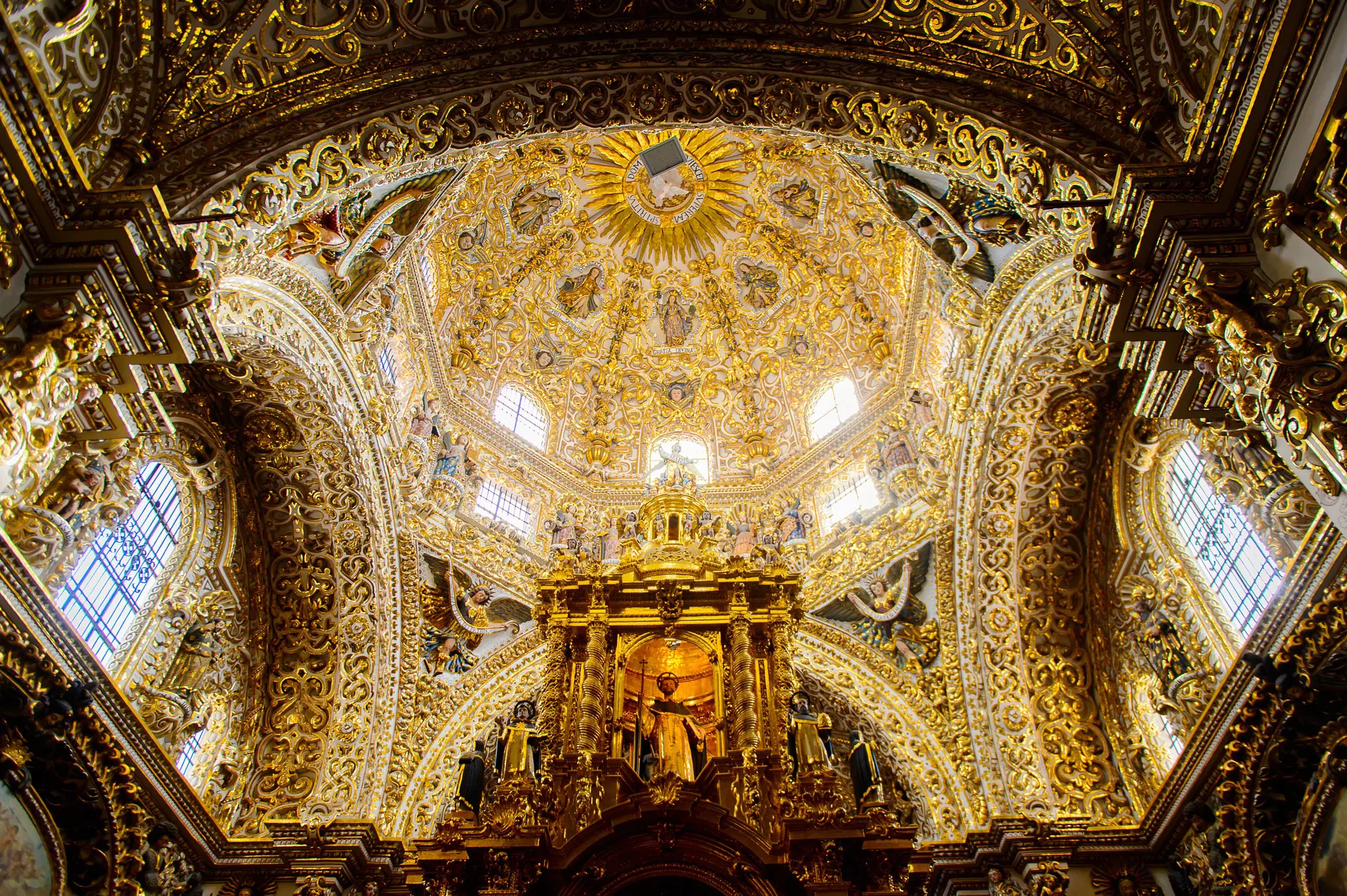The ornate, gold-leaf-covered interior of a church.