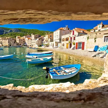 Boats moored next to a pebble beach in Croatia