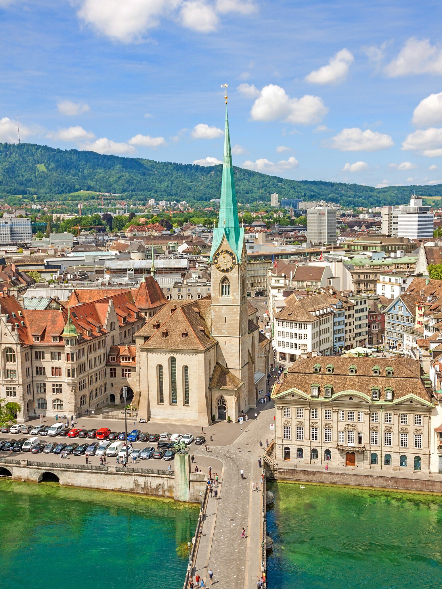 Aerial view of historic Zurich city center with famous Fraumunster Church and river Limmat at Lake Zurich from Grossmunster Church on a sunny day with clouds in summer, Canton of Zurich, Switzerland  License Type: media  Download Time: 2021-04-07T11:19:27.000Z  User: aniabartoszek  Is Editorial: No  purchase_order:   