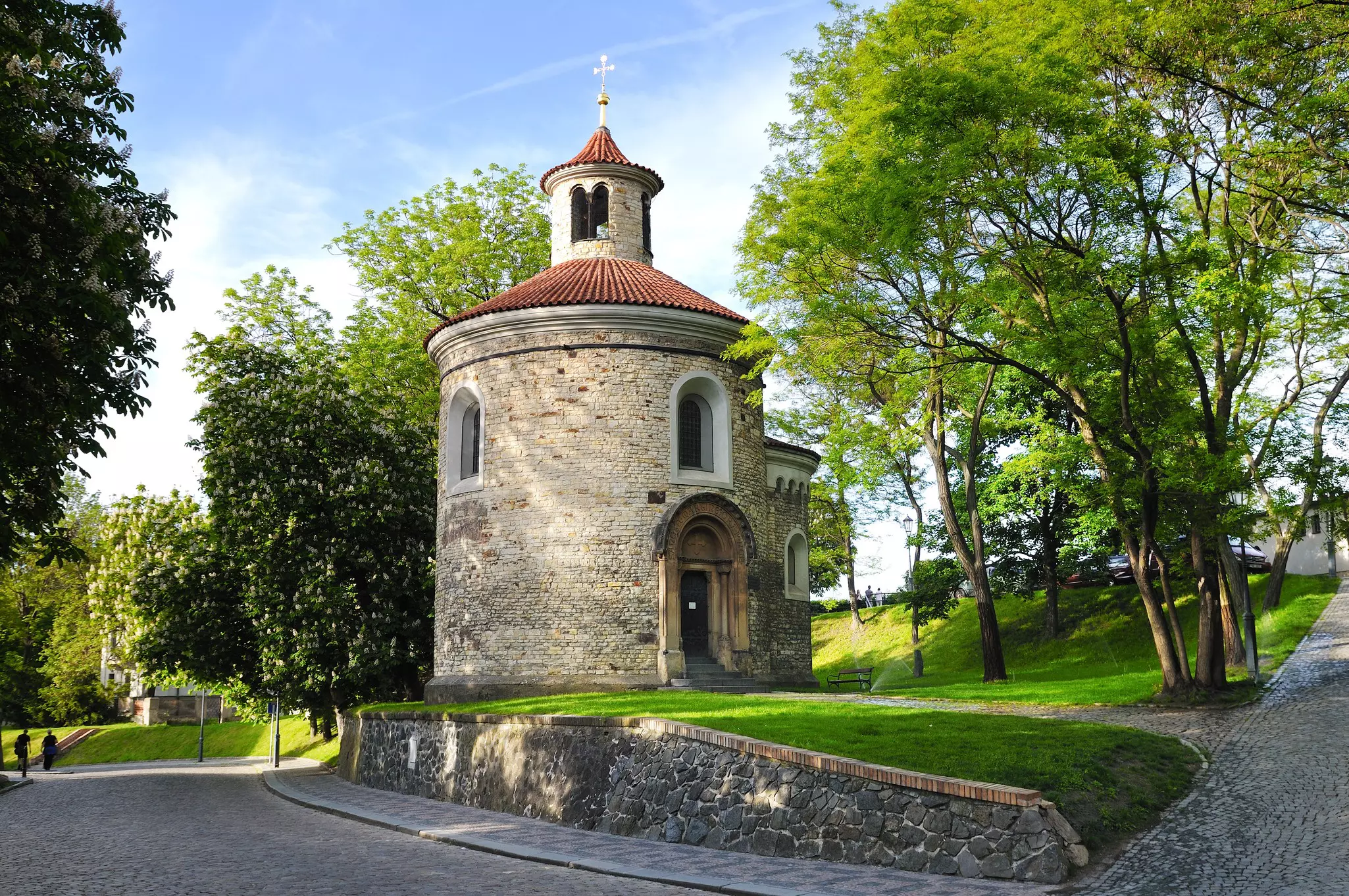 View of the Rotunda of St Martin surrounded by greenery in Prague, Czechia.