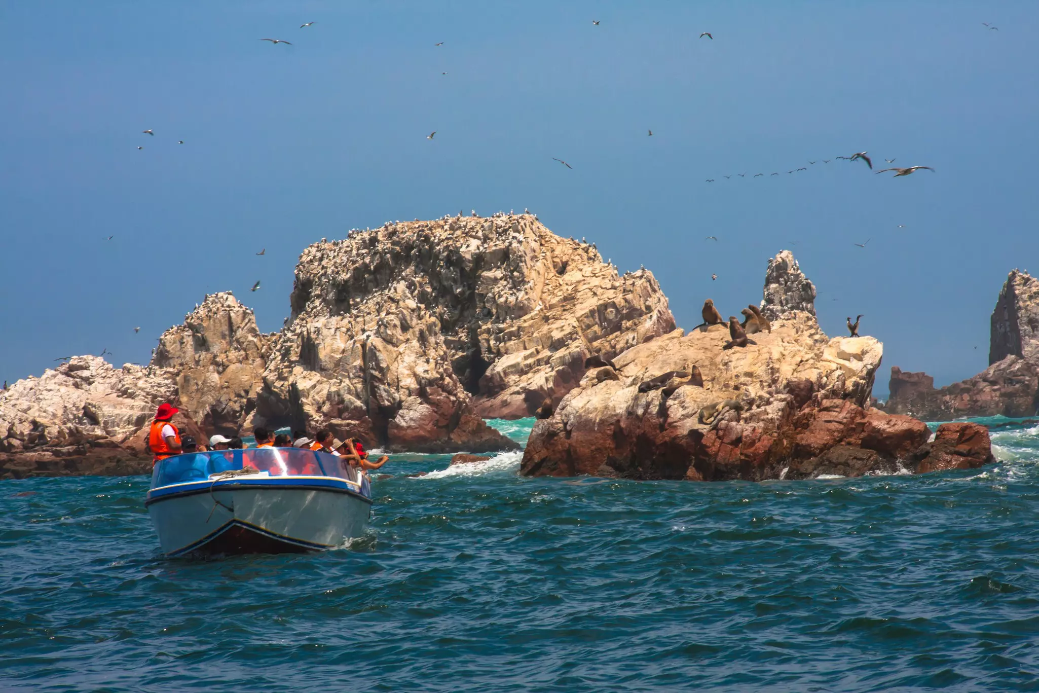 Tourists on a boat in the Ballestas Islands, Peru. 