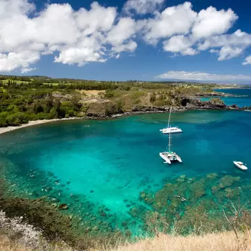 Honolua bay in Kalplua Maui, Hawaii with snorkel boats in afternoon.