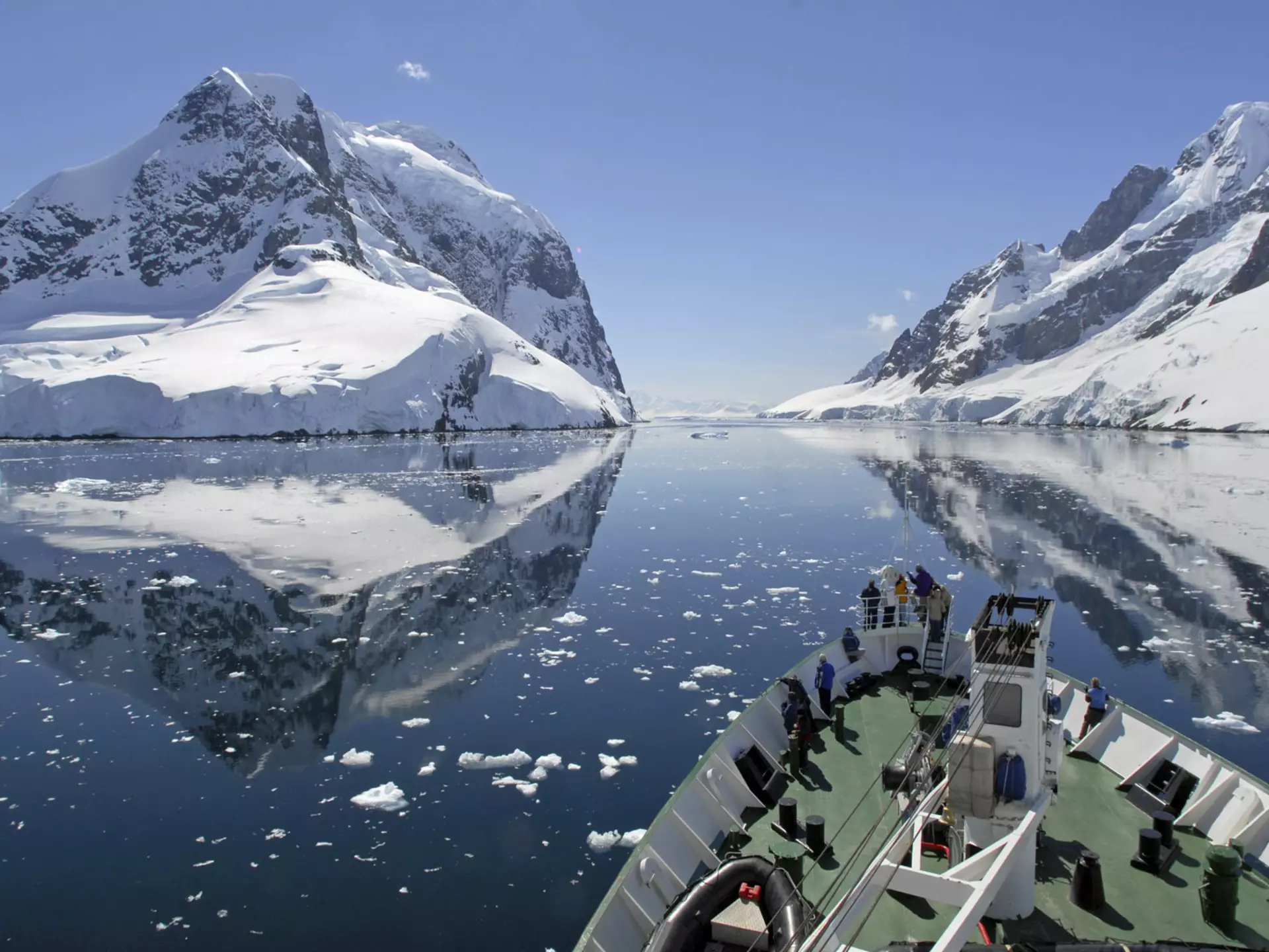 A small cruise ship makes passage through the Lemaire Channel in Antarctica