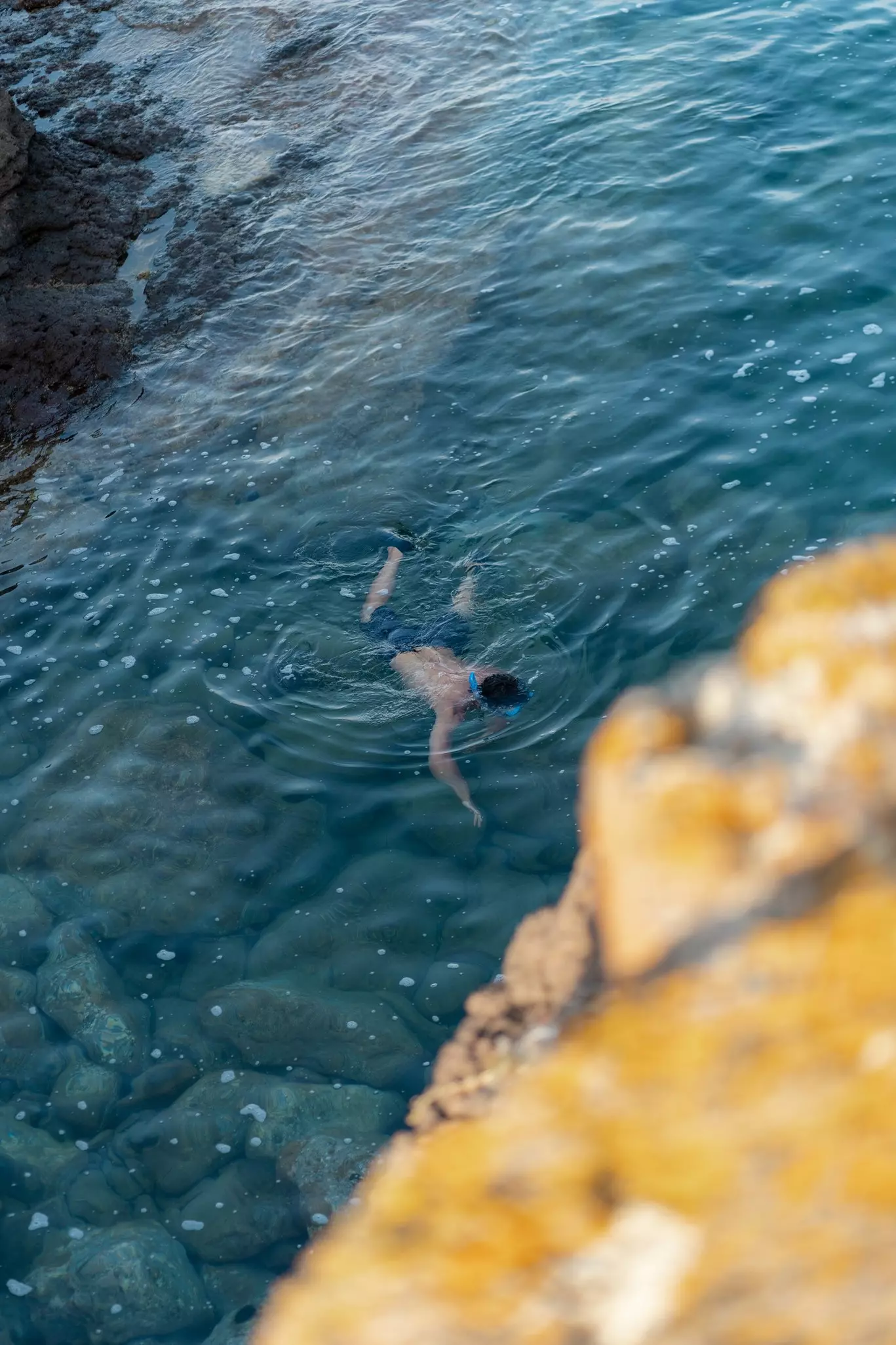 Person snorkeling in Sardinia in clear water