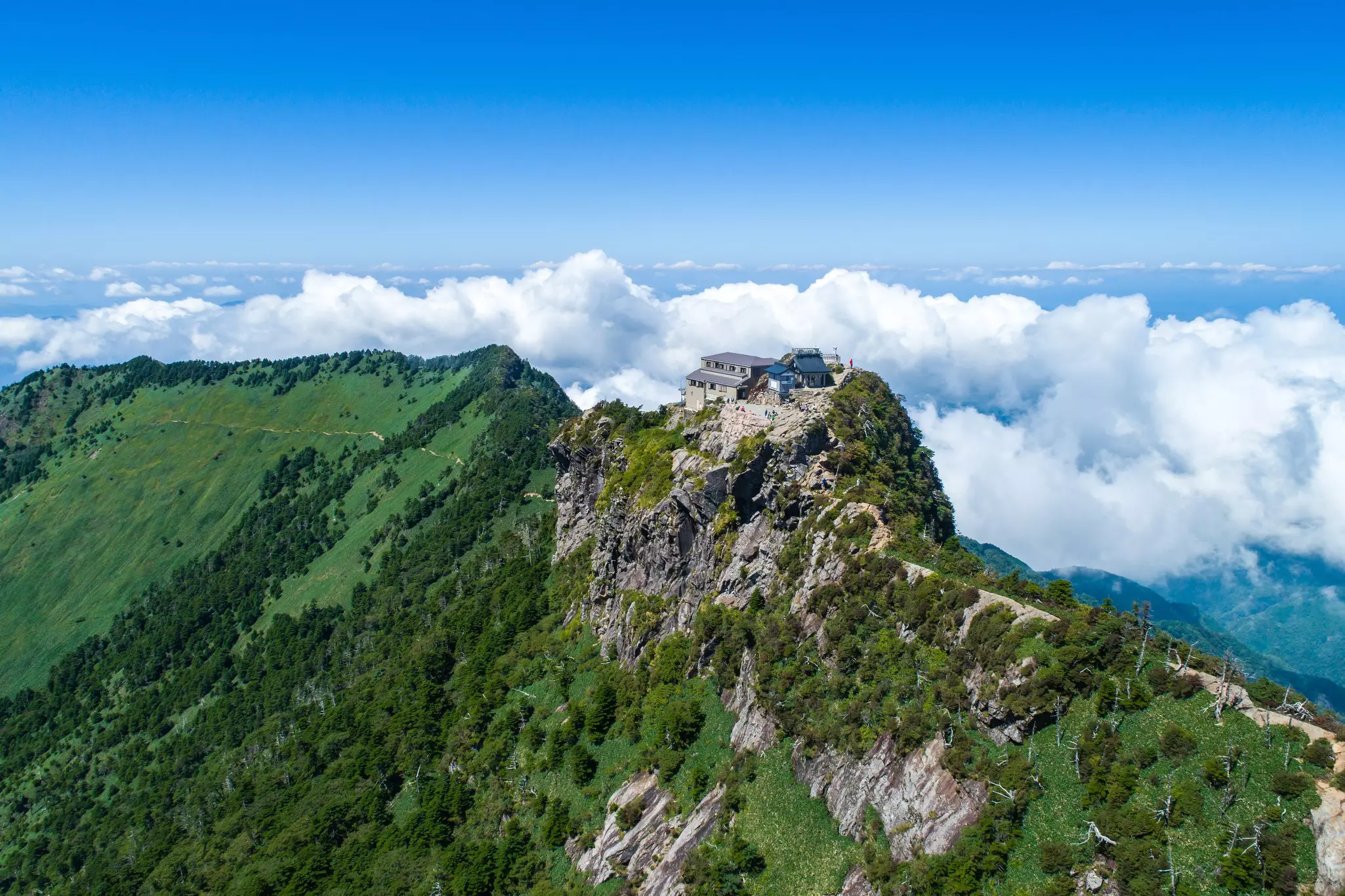 A mountain peak with a small temple at the top.