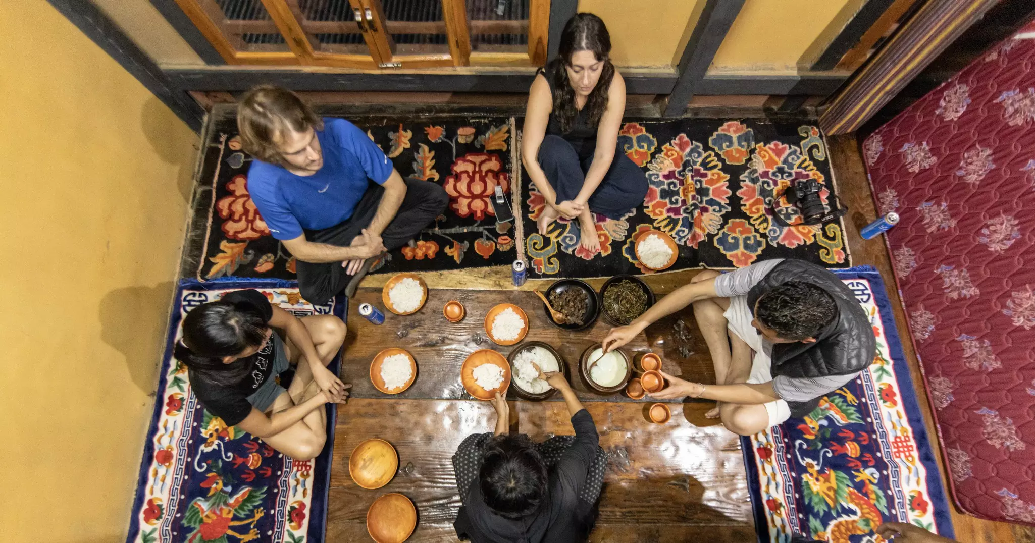 Travelers enjoyed a traditional meal at a homestay along the Trans Bhutan Trail. © Ken Spence