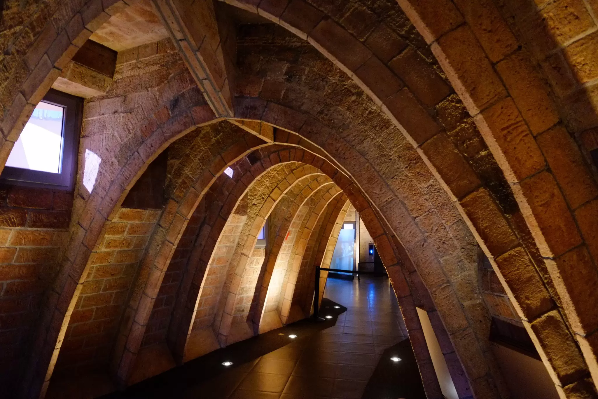 An arched walkway inside Palau Güell in Barcelona.