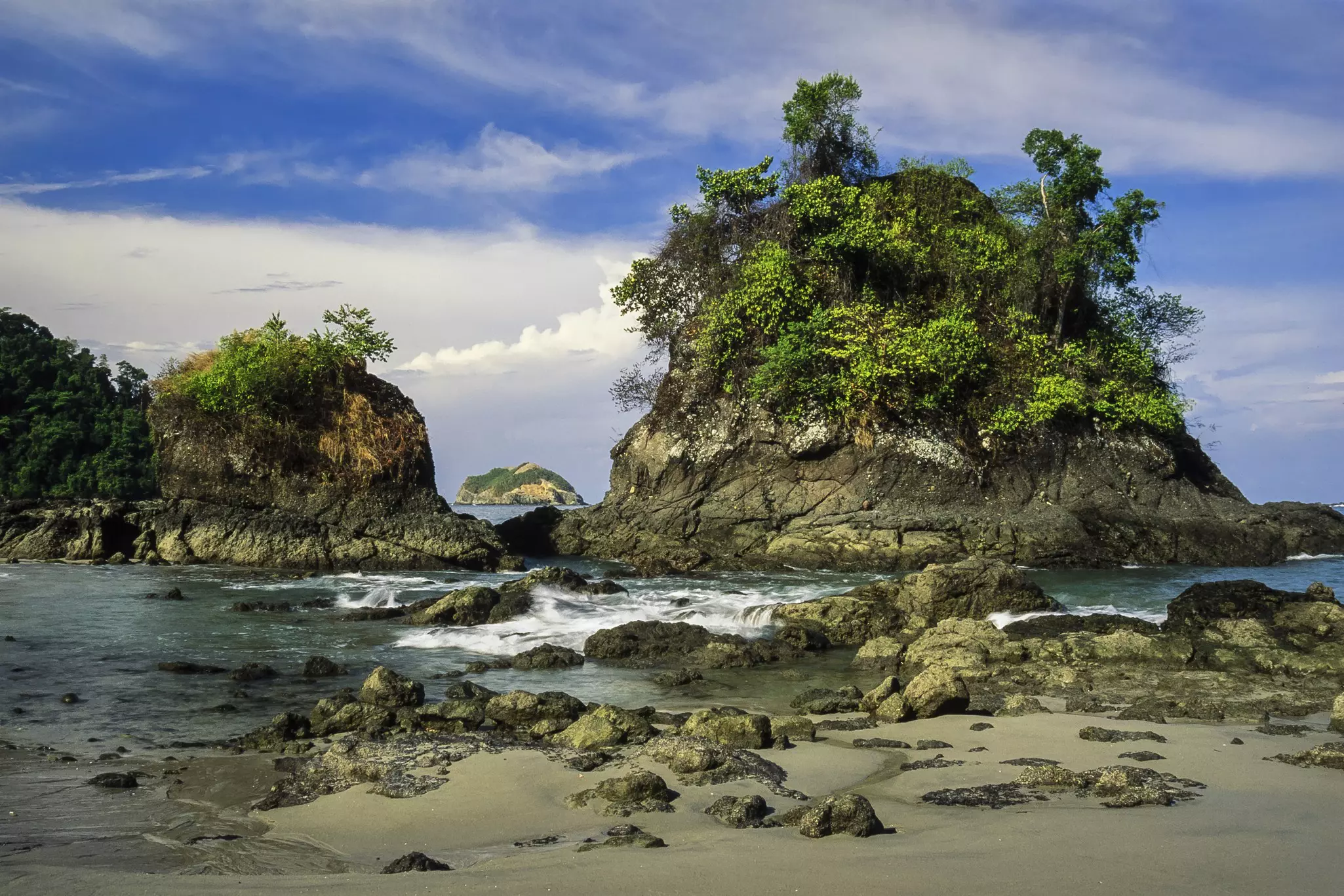 Islands covered with trees on the beach of Manuel Antonio National Park in Costa Rica.