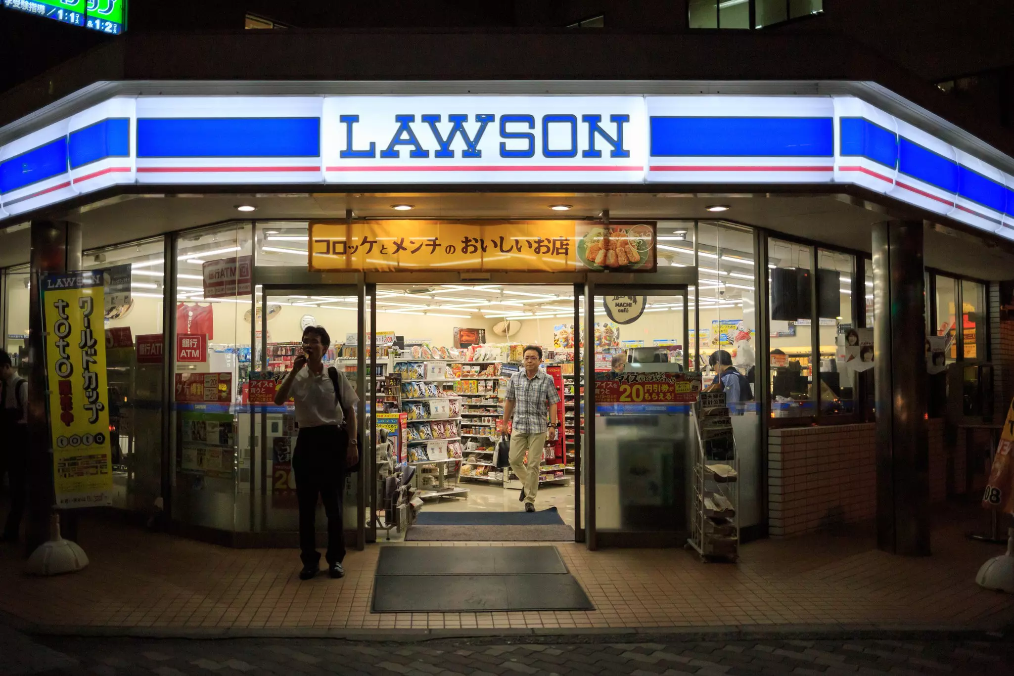 Customers in front of Lawson convenience store at night