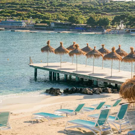 beach umbrellas with water in the background 