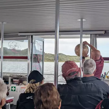 WALPOLE, WESTERN AUSTRALIA, AUSTRALIA, OCTOBER 2025.
Tourists enjoying the WOW Wilderness EcoCruise tour, sitting on a boat with the tour guide speaking up front and the inlet in the background.
Assigning editor: Jessica Lockhart
